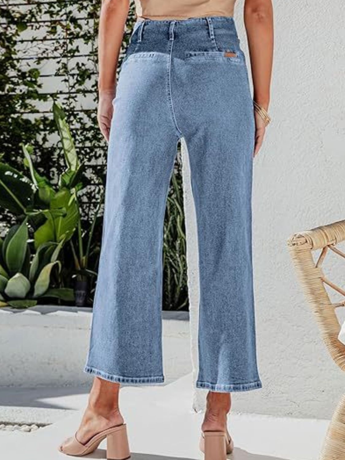 Light blue denim button-front wide-leg cropped jeans with frayed hem