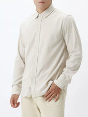 Apricot long sleeve buttoned shirt with a classic collar.