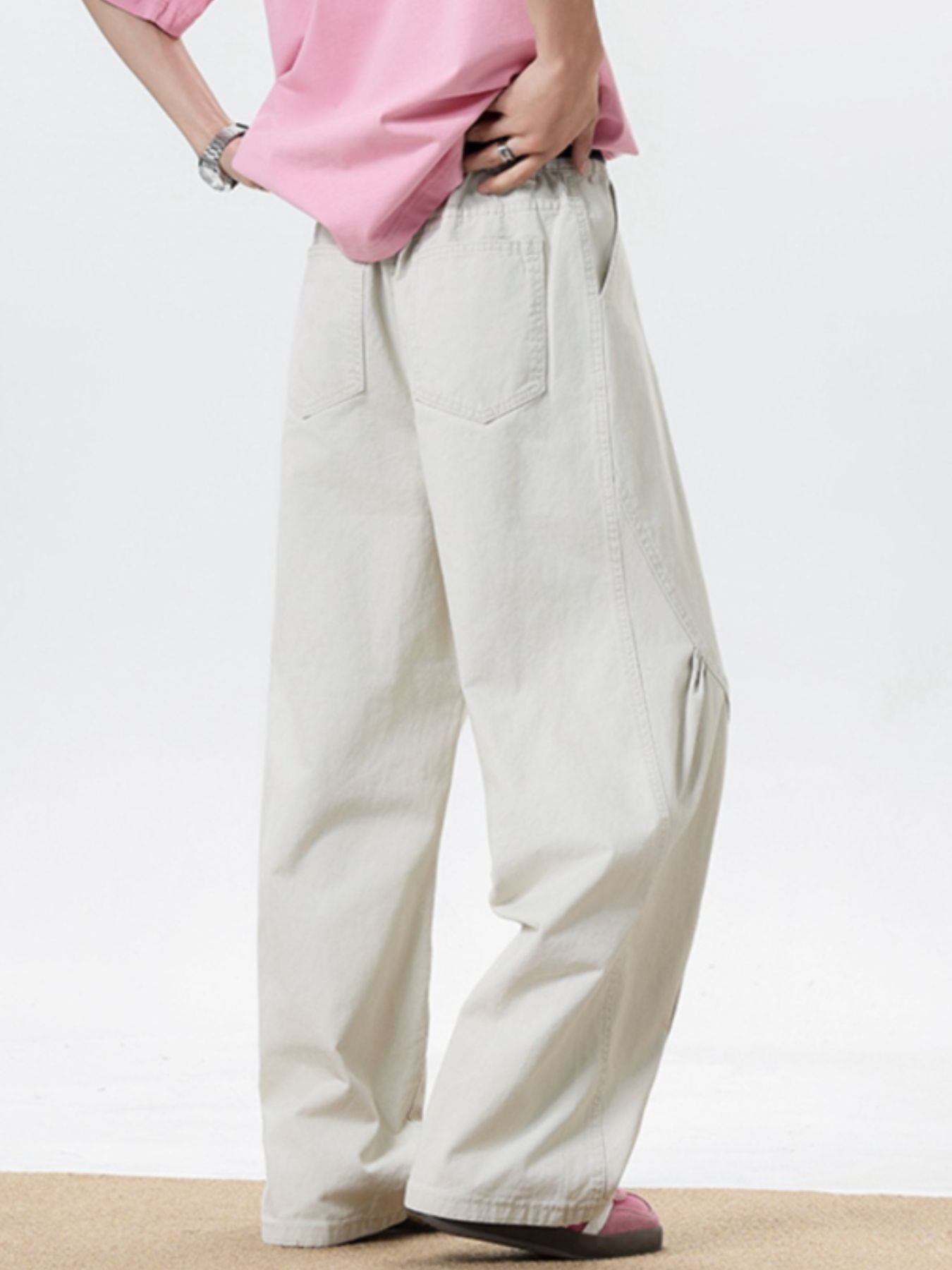 Men's cream wide leg sweatpants with elastic waist and pockets.