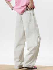 Men's cream wide leg sweatpants with elastic waist and pockets.