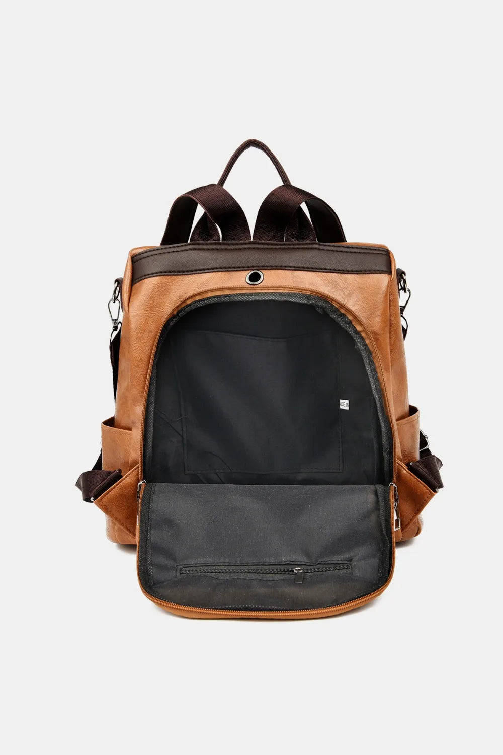 Caramel leather convertible backpack with open main compartment and zippered pocket.