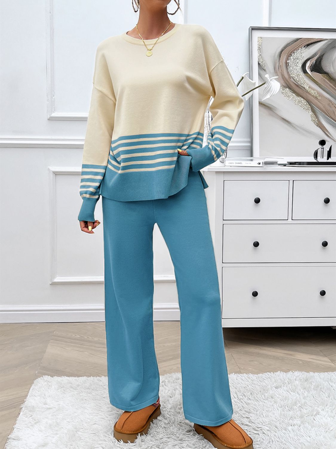Color-blocked knit lounge set with pastel blue pants and cream top with blue stripes.