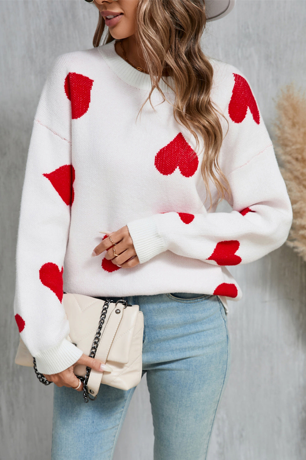 White acrylic knit jumper with red intarsia hearts, crew neck, long sleeves.