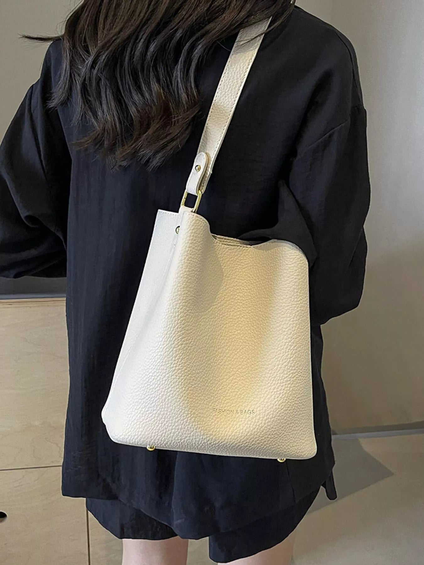 Off-white pebbled leather mini tote bag with gold hardware and a single strap.