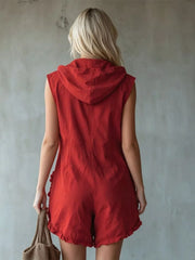 Red hooded sleeveless romper with ruffled pockets and hem.