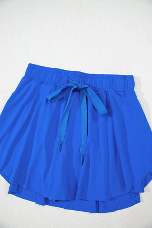 Blue flared skort with elastic waist and tie detail
