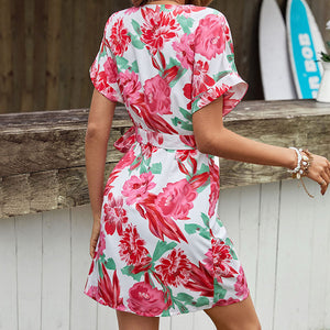 Floral wrap mini dress with flutter sleeves and a tie waist.
