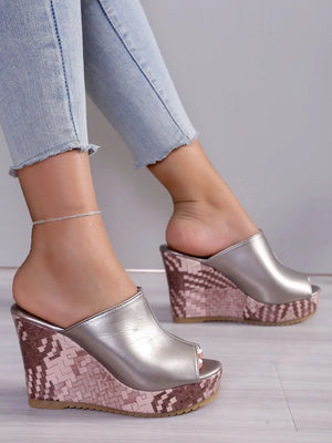 Textured wedge mules with open toe in silver, featuring a patterned wedge heel.