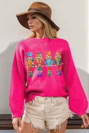 Hot pink knit sweater with sequin nutcracker embellishments and balloon sleeves.
