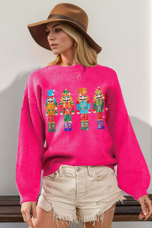 Hot pink knit sweater with sequin nutcracker embellishments and balloon sleeves.