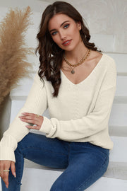 Relaxed knit V-neck pullover sweater in beige with long sleeves and a casual fit.