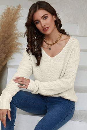 Relaxed knit V-neck pullover sweater in beige with long sleeves and a casual fit.
