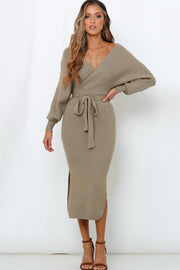 Khaki wrap-front midi knit dress with long sleeves, a belted waist, and a side slit.