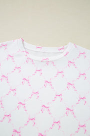 White loungewear set with pink bow print and scalloped edges.