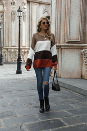 Crewneck knit sweater with color blocking in brown, white, dark gray, and rust.