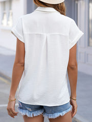 White crinkled short sleeve button-down shirt with cuffed sleeves and back pleats.