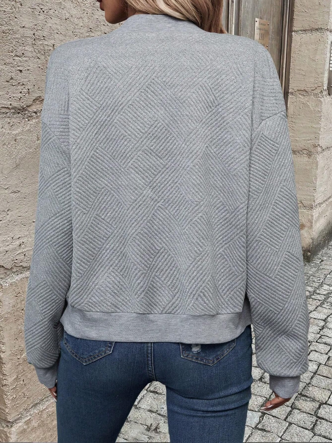 Gray geometric quilted bomber jacket with ribbed cuffs and hem.