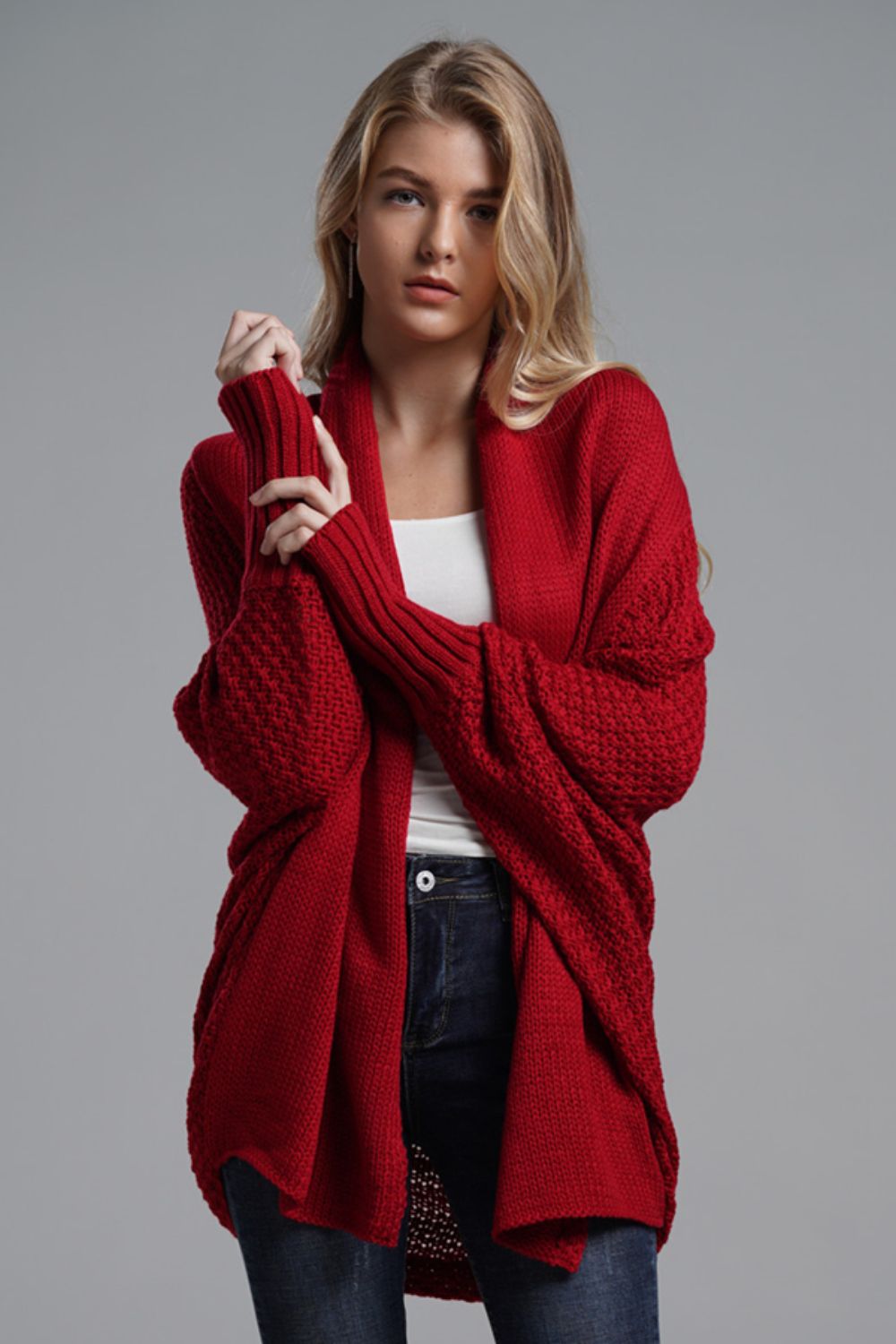 Red knit cardigan with batwing sleeves and a drape front.