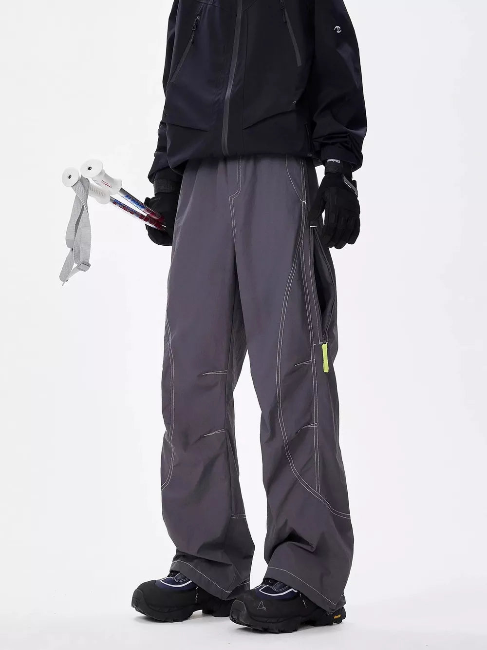 Men's gray loose fit cargo sweatpants with contrast stitching and yellow zipper detail.