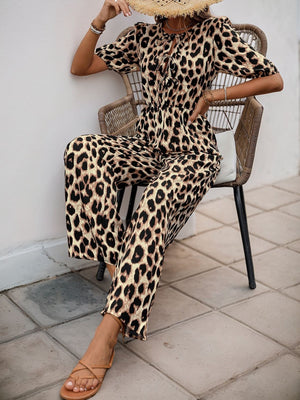 Leopard print puff sleeve jumpsuit with tie neck and wide legs.