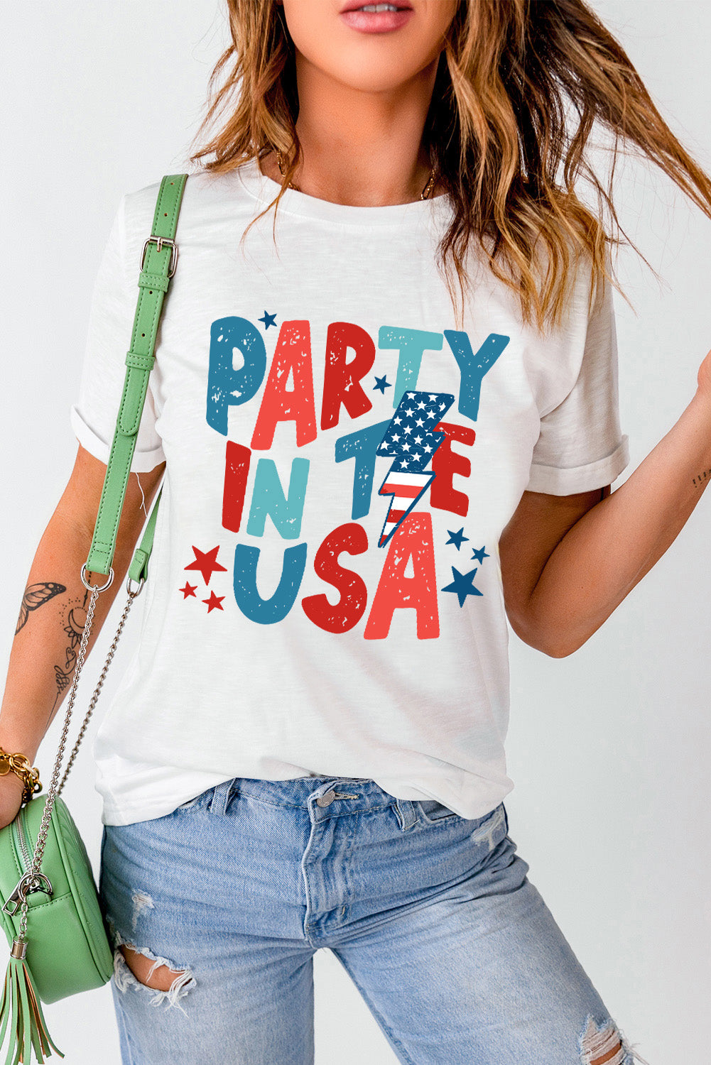 White t-shirt with distressed red, white, and blue Party in the USA graphic and lightning bolt USA flag.