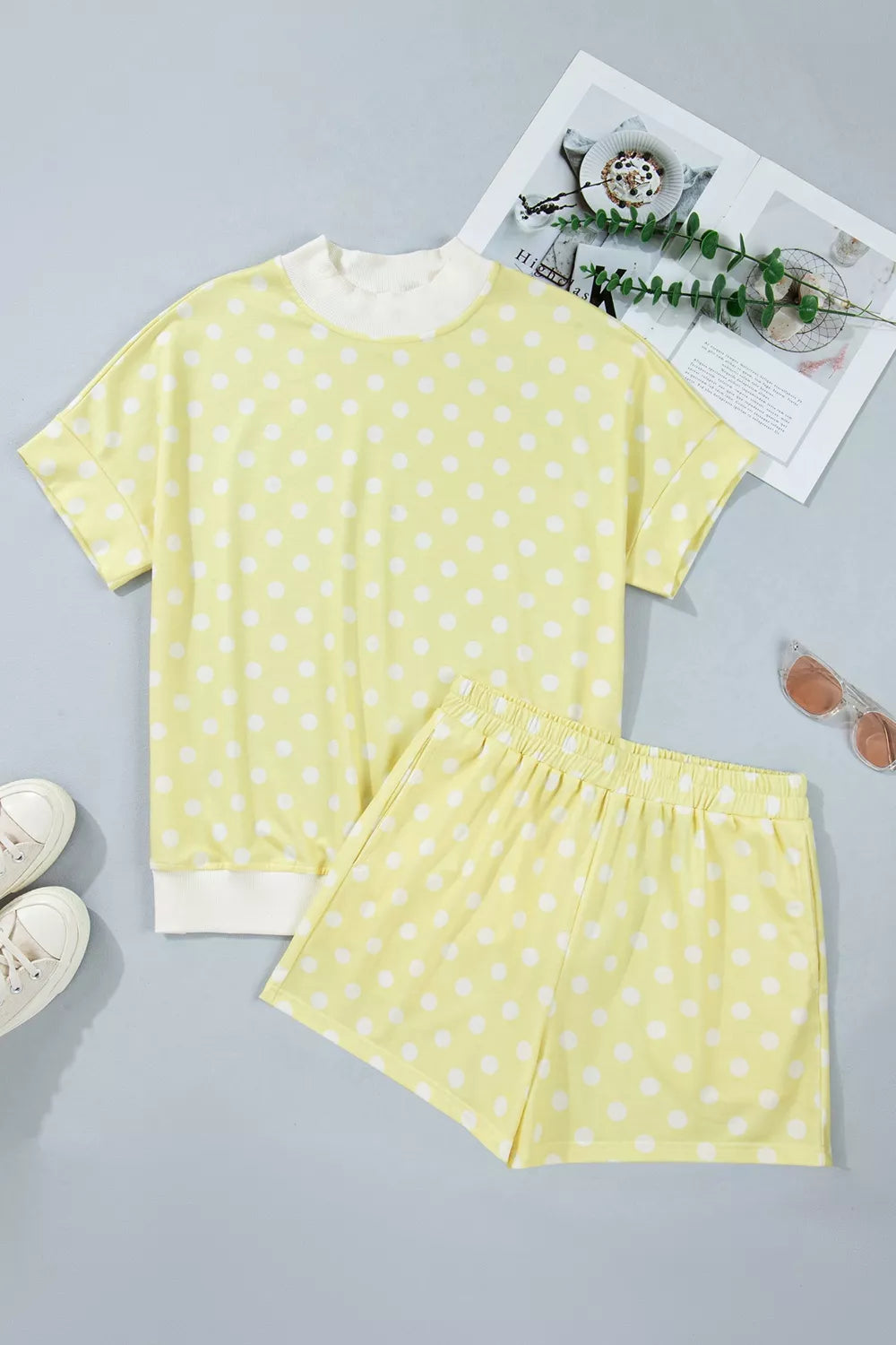 Pastel yellow polka dot top and shorts set with white trim, polyester.