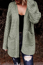 Sage open-knit pocket cardigan with textured cable knit pattern and open front.