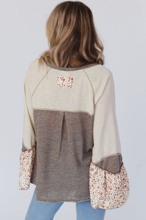 Floral bell sleeve top in mocha with contrasting panels and ruffled floral cuffs.