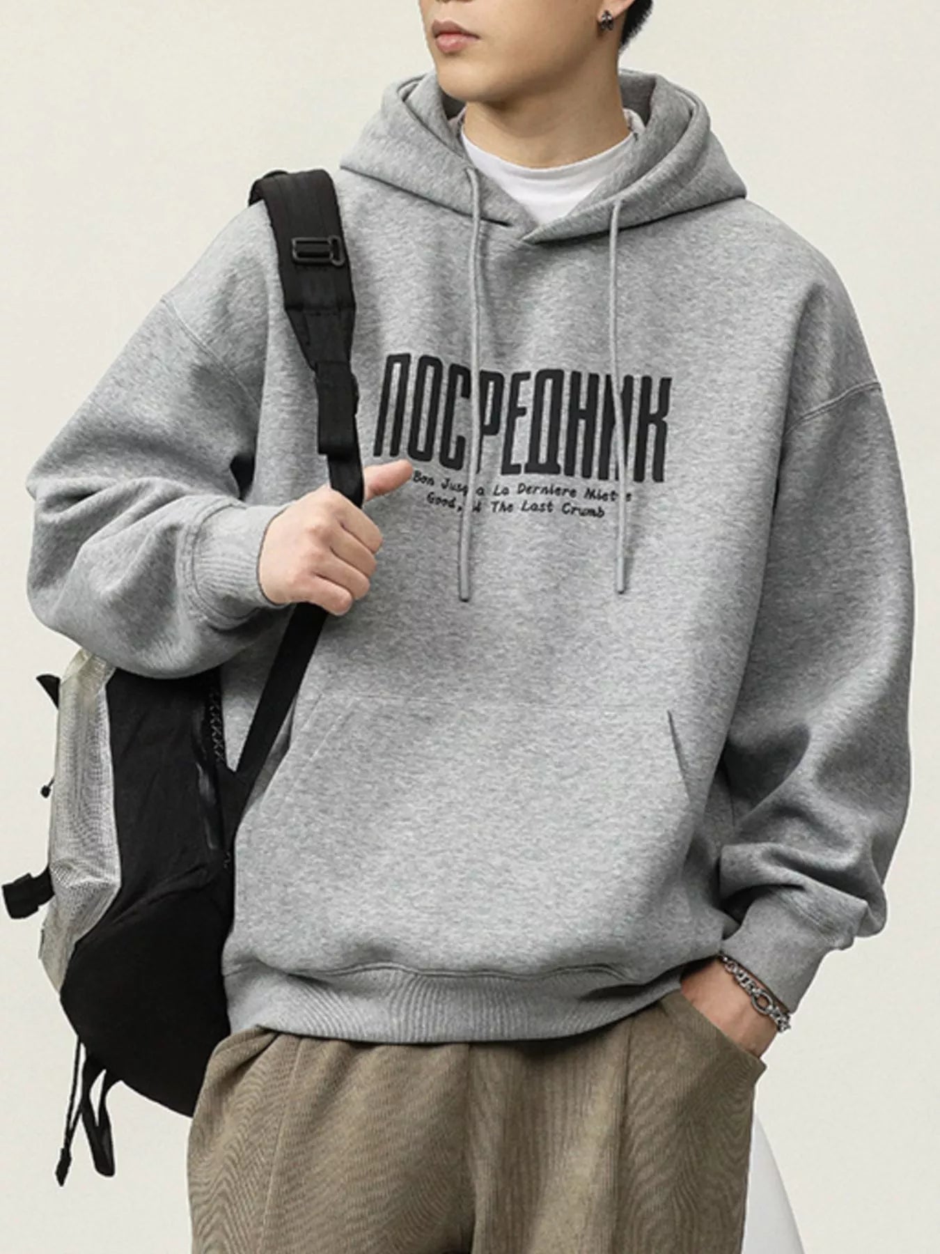 Gray cotton drawstring hoodie with black graphic text and a front pocket.