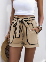 Tan paperbag shorts with black scalloped trim and tie waist.