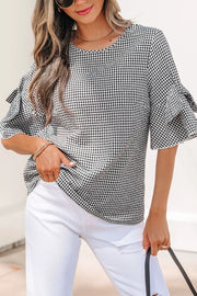 Gingham ruffled sleeve shirt in black and white polyester with a crew neck.
