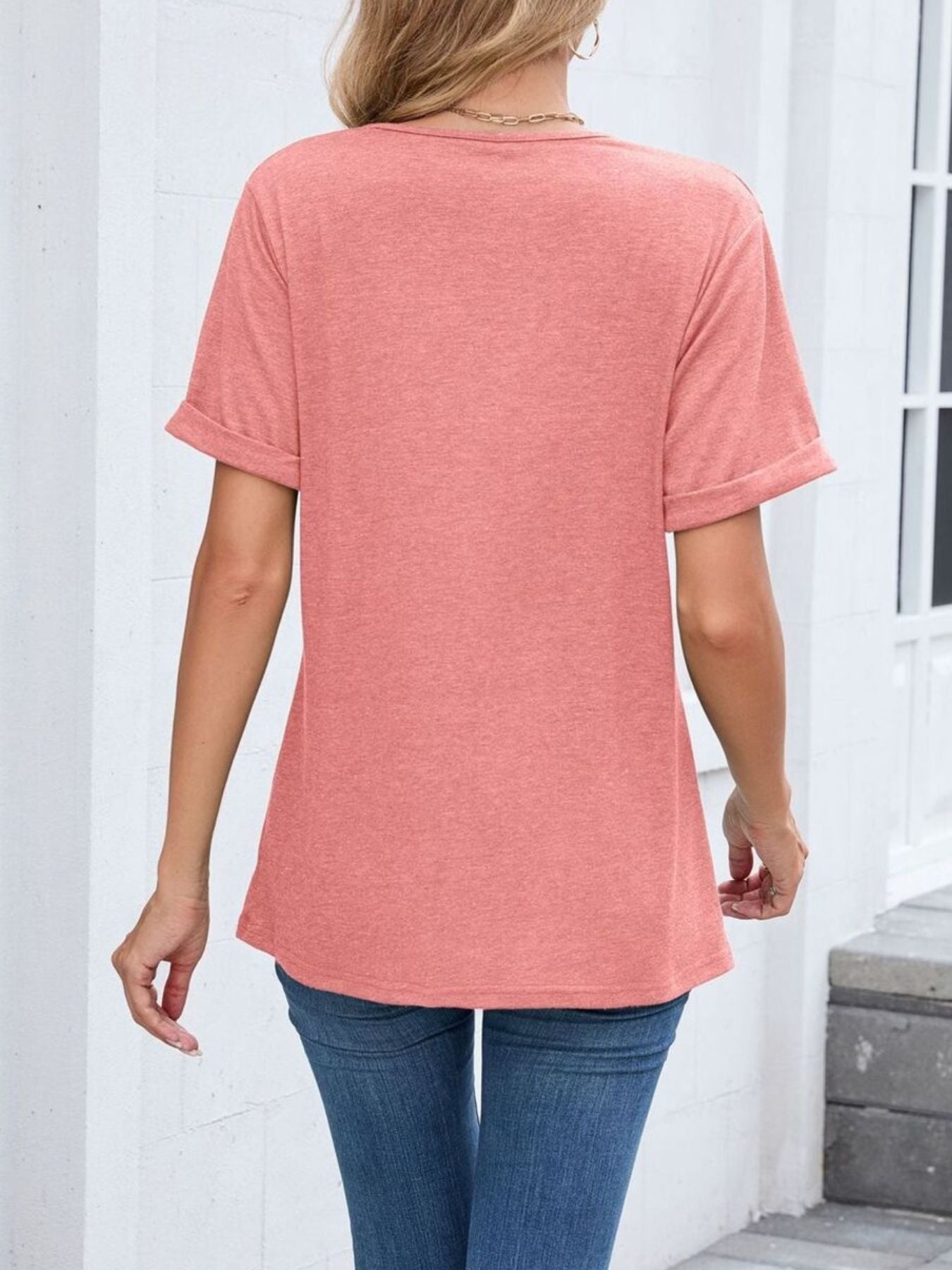 Pink v-neck t-shirt with cuffed short sleeves and a relaxed fit.