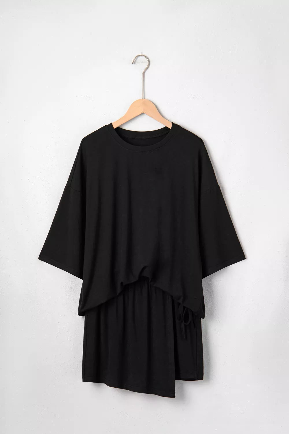 Black tie-wrap two-piece ensemble with asymmetric hem and drawstring detail
