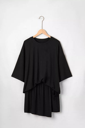 Black tie-wrap two-piece ensemble with asymmetric hem and drawstring detail