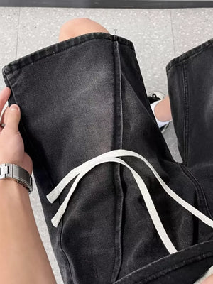 Black denim shorts with drawstring waist and contrast stitching.