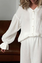 White gauze loungewear set with voluminous sleeves and ruffled cuffs.