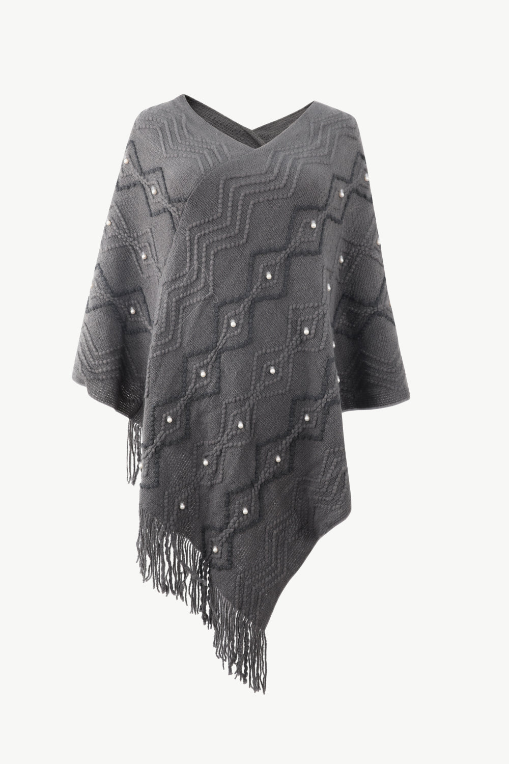 Charcoal geometric knit poncho with pearl embellishments and fringe detail.