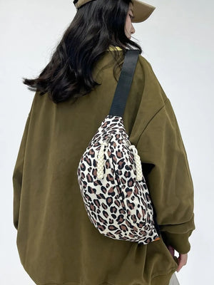 Pleated leopard print sling bag with rope detail and black strap.
