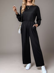 Black long sleeve wide leg jumpsuit with elastic waist and pockets.