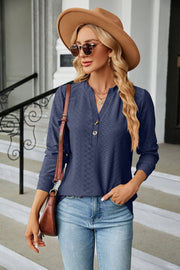 Dark Blue textured henley blouse with button detail and long sleeves.