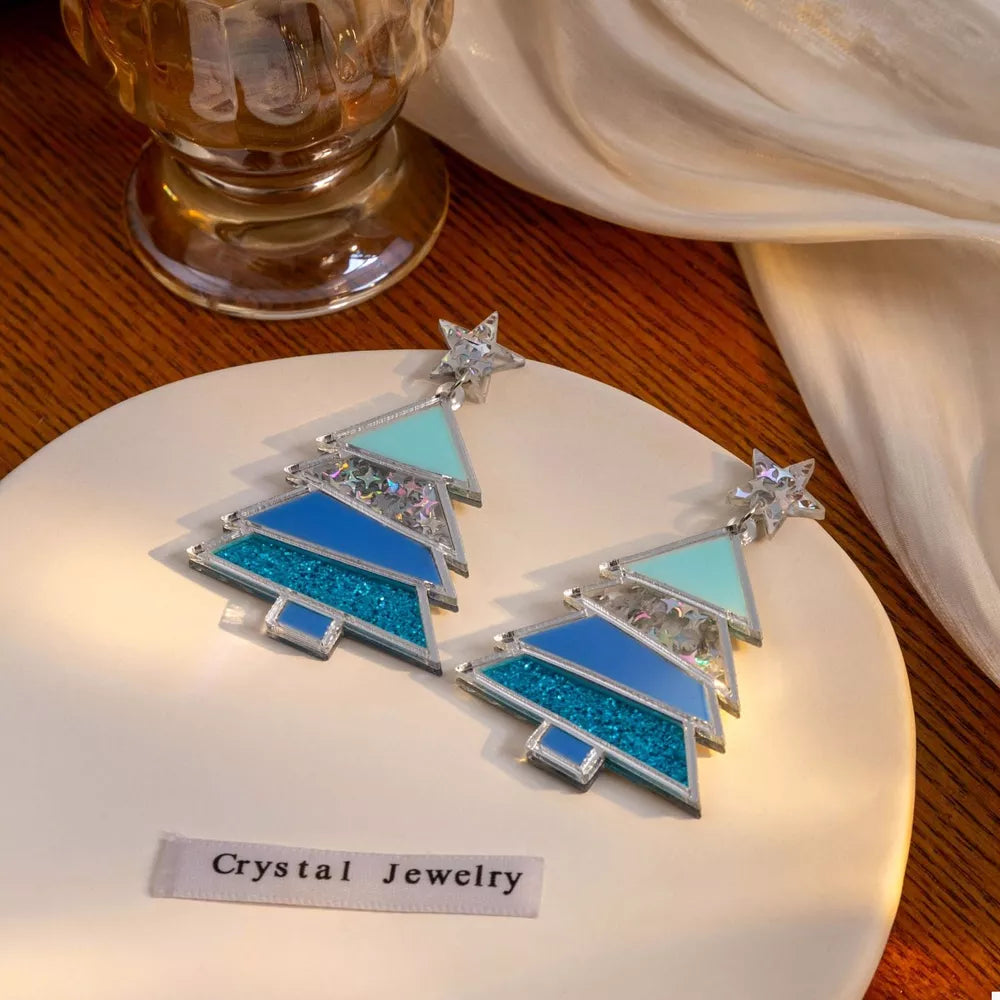 Acrylic Christmas tree dangle earrings with blue and silver confetti details.