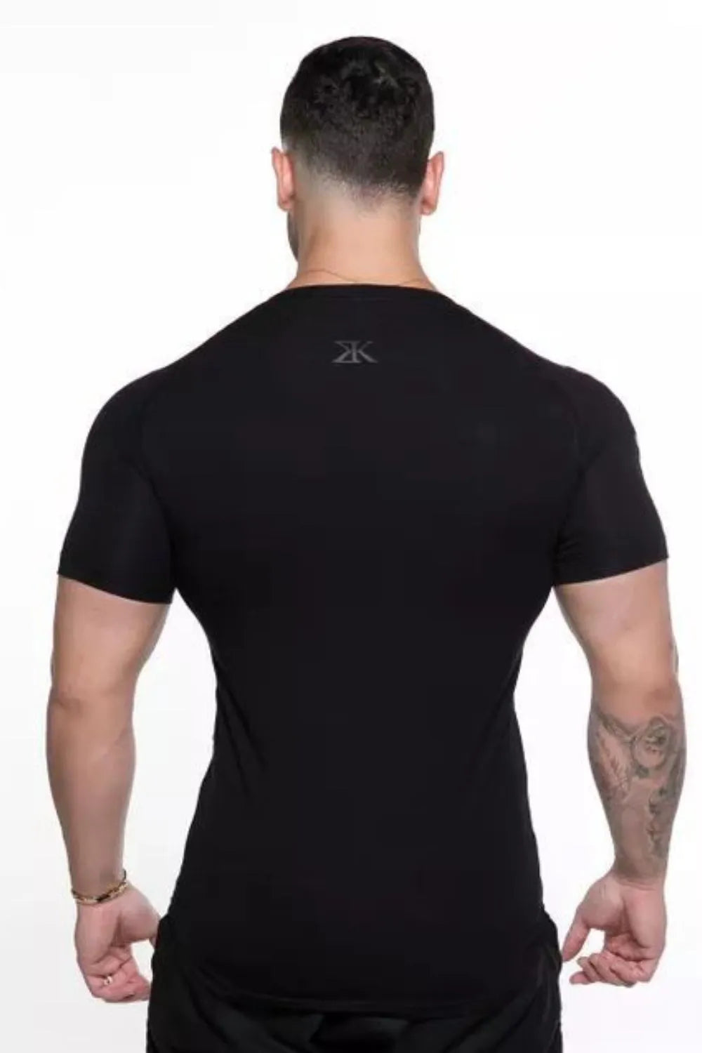 Black performance tee with subtle shoulder print detail, crew neck, short sleeves.