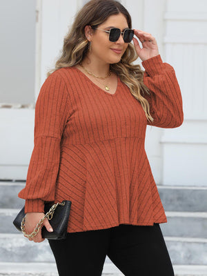 Ribbed peplum blouse in Red Orange with blouson sleeves and V-neck.