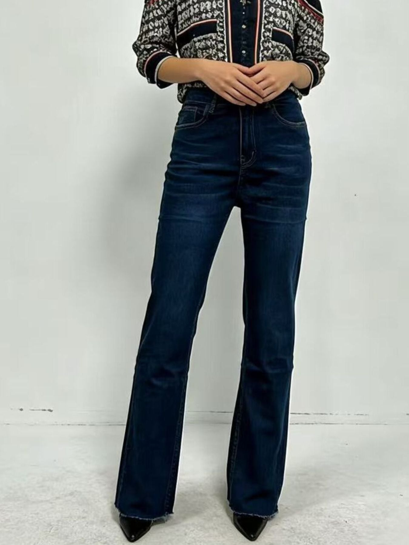 Maternity bootcut jeans in dark wash cotton with a high waist and frayed hem.