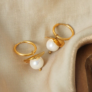 Golden petal pearl drop hoop earrings with white pearls and gold accents.