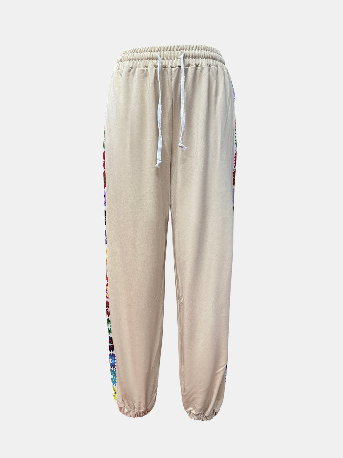 Tan jogger pants with colorful embroidered side stripes and drawstring waist