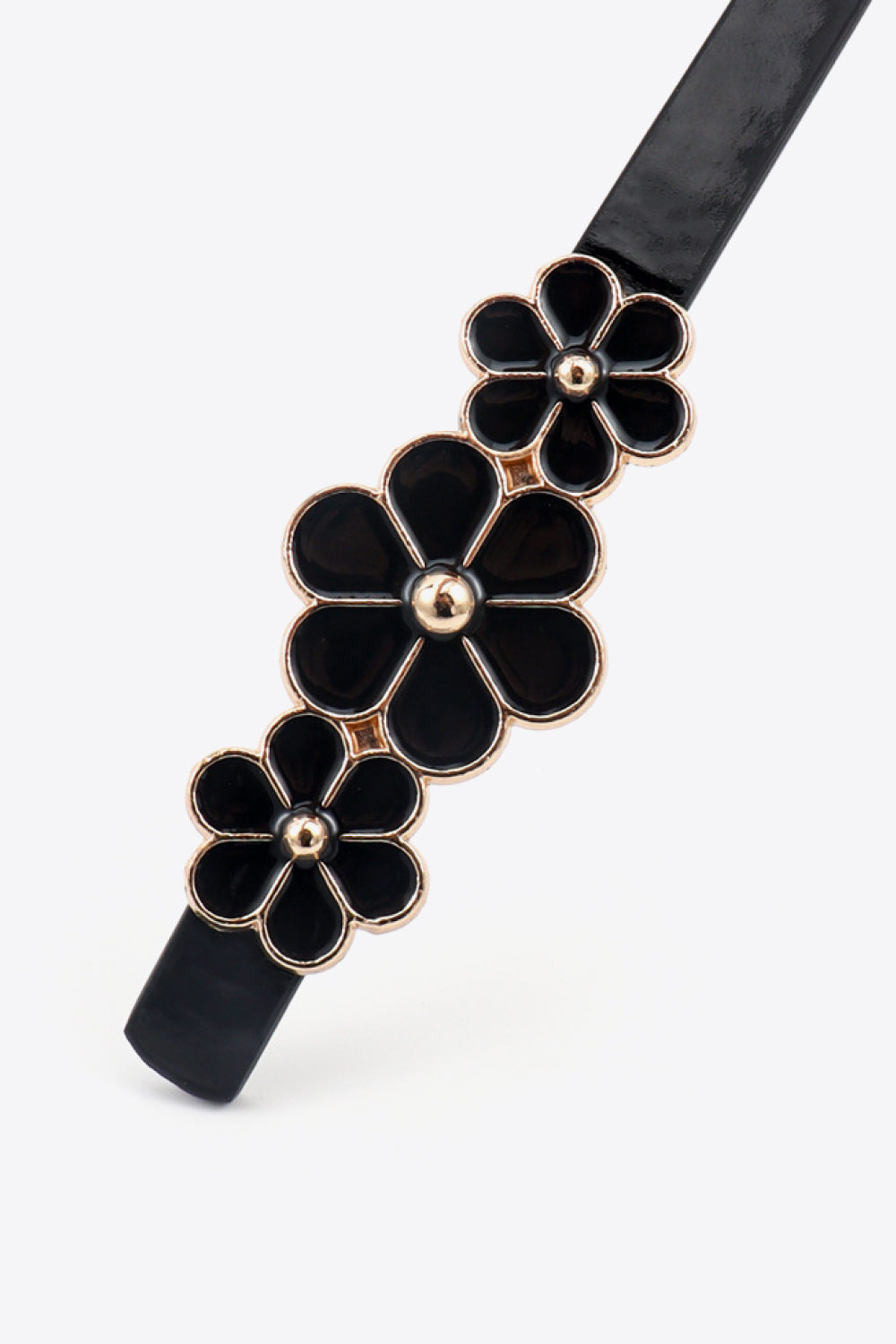 Black skinny belt with gold trim and black floral embellishments.