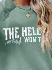 Green crewneck sweatshirt with white graphic text and floral detail