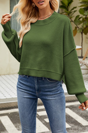 Boxy ribbed knit sweater in dark green with crewneck and balloon sleeves.