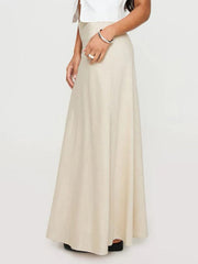Beige bias-cut maxi skirt with a flowing silhouette.